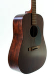 Acoustic guitar with a dark brown finish on a white background