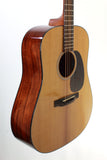 Acoustic guitar with a wooden finish on a white background