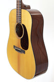 Acoustic guitar with a wooden body and dark brown neck on a white background
