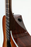 Close-up of a guitar neck and body on a white background