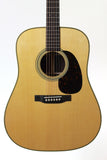 Acoustic guitar with a natural wood finish on a white background